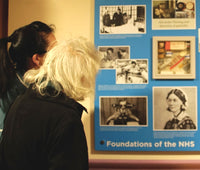 A service user enjoying reminiscence display artwork featuring a medical memory box and images relating to hospitals nurses and the NHS images 